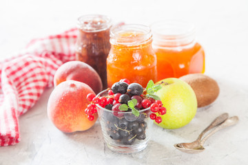 berries, fruit and jam on a table, selective focus