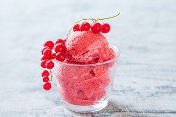 ice cream with berries in a glass on a table, selective focus