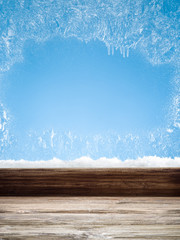 Wooden sill and frozen window. Christmas or New Year background.