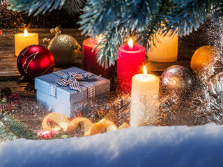 Gift boxes, candle lights and frozen window. Christmas backgroun