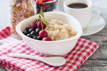 porridge with berries on a table, selective focus