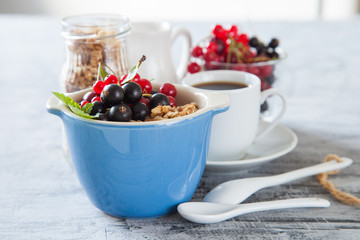 muesli with berries in a plate on a table, selective focus