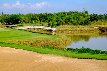 green golf field and blue cloud sky for backdrop background use
