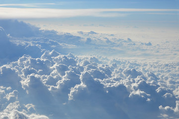 Naklejka premium Sky scenery. Aerial view over the cumulus clouds on a sunny day.