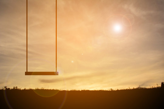Silhouette of swing at the sky sunset vintage tone and alone feeling
