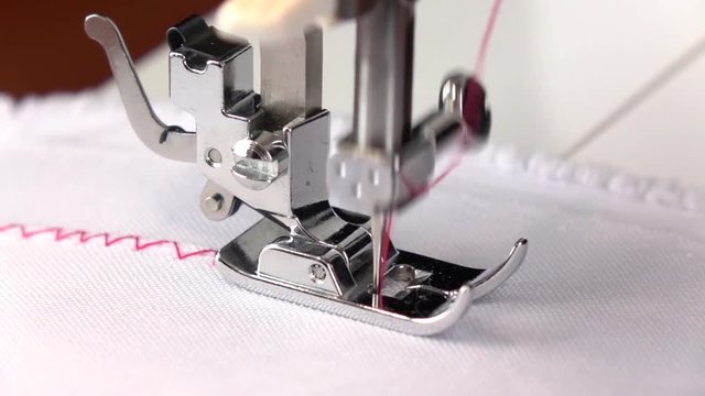 Sewing machine. Zigzag seam with different thread tension. Slow motion