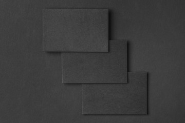 Mockup of horizontal business cards at black textured paper
