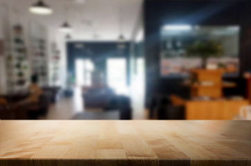 Selected focus empty brown wooden table and Coffee shop blur bac