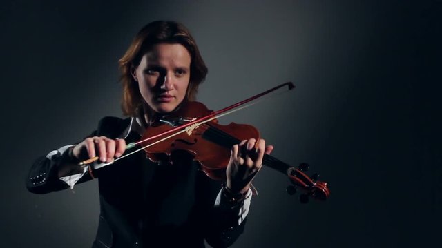 Woman Playing On Violin In A Studio. Black Backgraund
