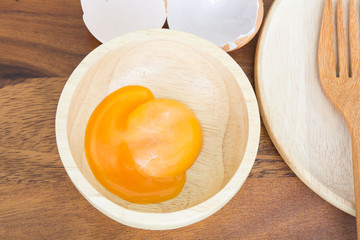 egg yolks in a bowl on wooden table prepared food