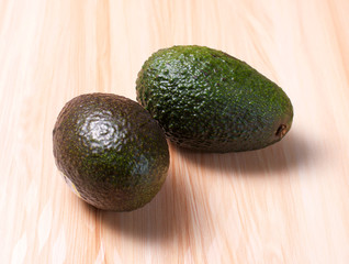 Avocados on wooden board