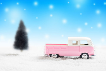 Miniature toy vintage cars with Christmas background with snowy