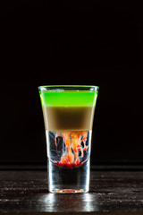 Colorful alcoholic cocktail in a shot glass