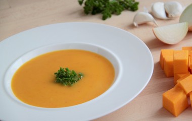 Creamy vegetable pumpkin soup with garlic and parsley.