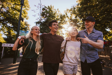 Four friends strolling in amusement park