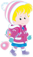 Little schoolgirl in a winter jacket and a warm hat and mittens going with a schoolbag