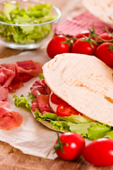 Piadina with ham and lettuce.