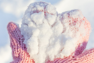 Snow on pink gloves