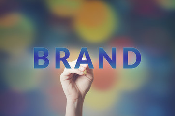 Man Hand writing Brand with marker on visual screen