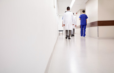 group of medics or doctors walking along hospital