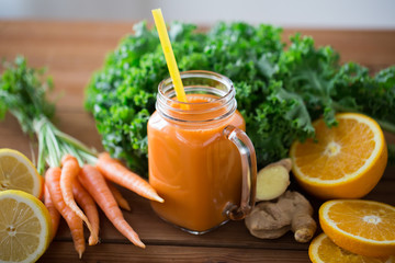 glass jug of carrot juice, fruits and vegetables