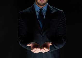 close up of businessman holding something in hands