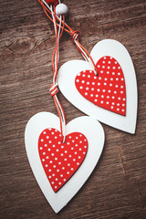 White and red sewed christmas hearts on wooden background,  for greetings Valentine's  day