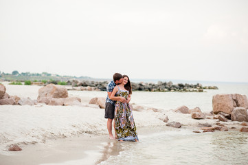 Beautiful young couple walks on sea