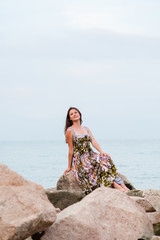 Young girl on the rocks in the sea