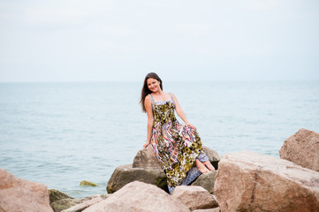 Young girl on the rocks in the sea