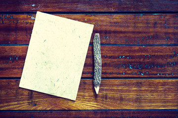 Wooden Pencils on mulberry paper on wooden background with copy