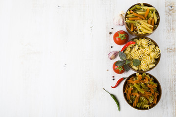 Pasta and ingredients: chili, tomatoes, basil, garlic and parsle