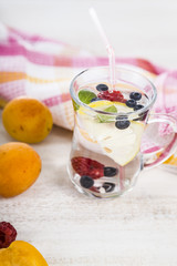 Homemade lemonade with fresh berries on a wooden table.Cocktail
