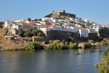 Fototapeta na wymiar MERTOLA, PORTUGAL: General view of the fortified village from the opposite bank of the river Guadiana