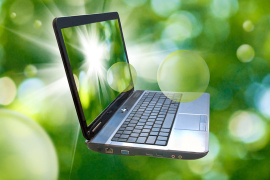 Image of laptop on abstract green background