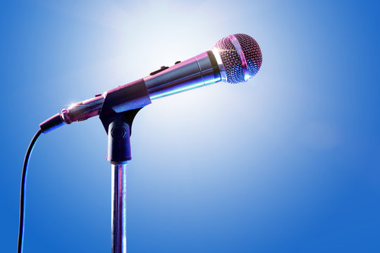 Microphone on microphone stand with blue background