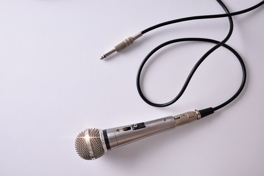 Wired microphone with jack connector on white table top view