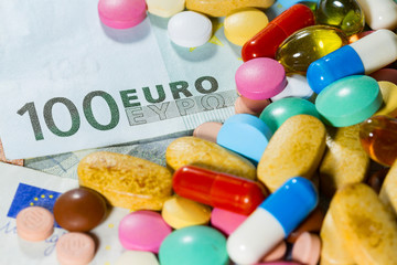 Euro banknotes with medical pills