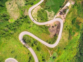 Foto op Plexiglas Luchtfoto Aerial view of crooked path of road on the mountain, Shot from d