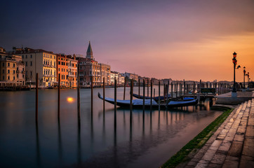 San Marco Campanile with gondolas at Grand Canal during calm sunrise, Venice, Italy, Europe.