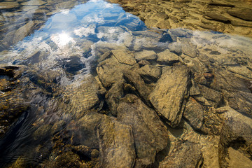 Stones in the clear water in the Altai
