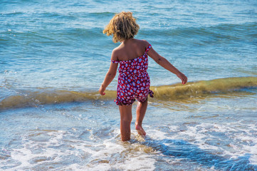girl walks into the sea