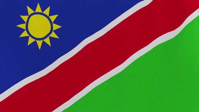 Loopable: Flag of Namibia...Namibian official flag gently waving in the wind. Highly detailed fabric texture for 4K resolution. 15 seconds loop.