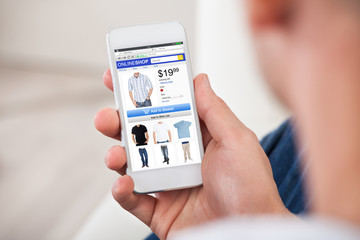 Close-up Of Man Shopping Online On Smartphone