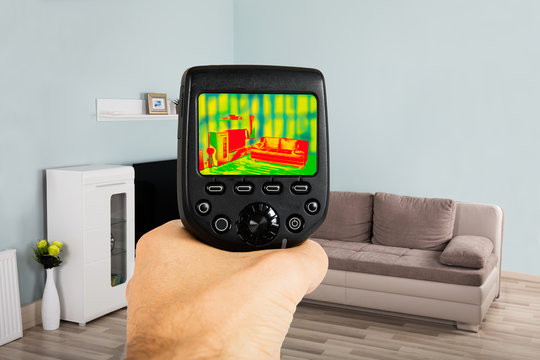 Person Hand Using Infrared Thermal Camera In Living Room