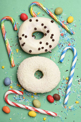 Glazed donuts on green background
