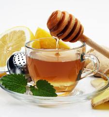 Ginger tea with lemon. Mint leaf. Mint leaves. Tea in a glass cup, mint leaves, dried tea, sliced...