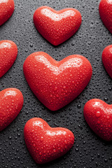 Fototapeta premium Red hearts on black background
