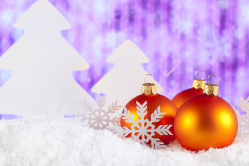 Christmas baubles and trees on snow