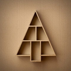 Christmas tree shaped gift box on cardboard background